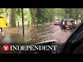 Heavy rains flood roads around London's Clapham Common