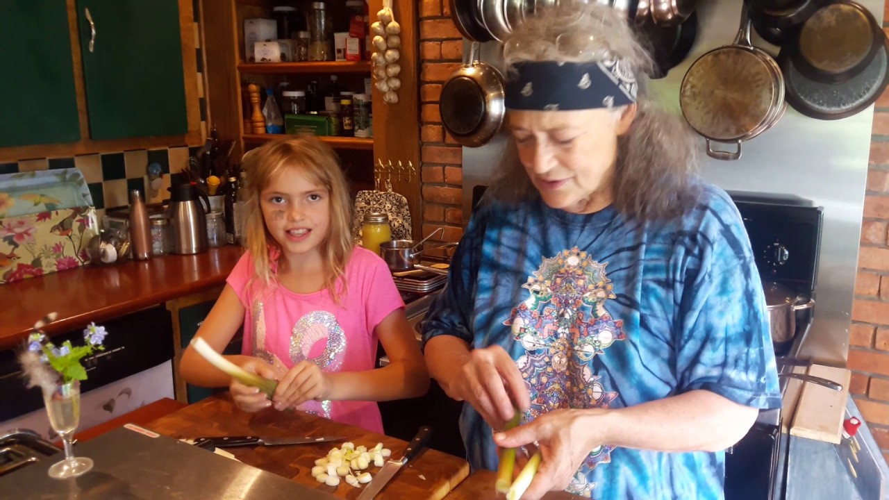 Susun and granddaughter in the Kitchen - cooking Cattails