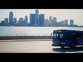 DETROIT LIONS DDOT GILLIG LOW FLOOR LOW EMISSION HYBRID DRIVING NEAR DOWNTOWN DETROIT RIVER 