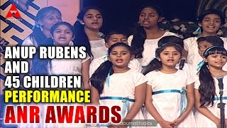 anup-rubens-and-45-children-live-perform-manam-movie-song-at-anr-awards