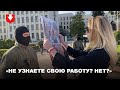 Девушка показывает силовикам плакаты с фотографиями избитых людей