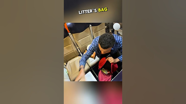 Two men sat together in aeroplane one eating and littering carelessly, while the other but #kindness