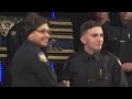 Shows phoenix police chief jeri williams giving tyler moldovan his badge at his graduation