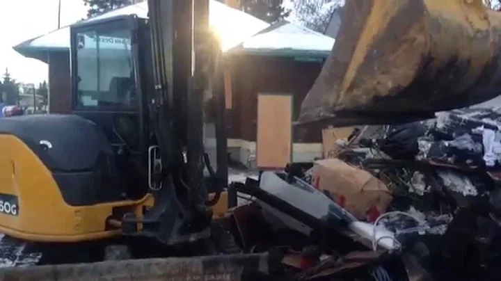 Demolition of garage in Calgary burned out by copper wire thieves.