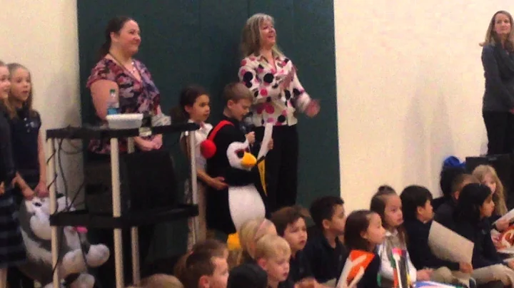 Caleb speaking at assembly - handing off Mr. Woddles