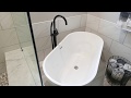 Bathroom remodel with freestanding soaking tub by Construction Specialties
