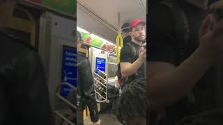 Person Hangs from Pole on Train