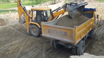 Jcb Backhoe machine loading soil in Heavy Truck