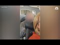 Man punches woman's reclined seat in plane, video goes viral