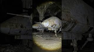 A graveyard where the engine's roar has been replaced by the steady drip of damp cave walls.