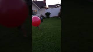Guy kicks yoga exercise ball that hits boy on the face