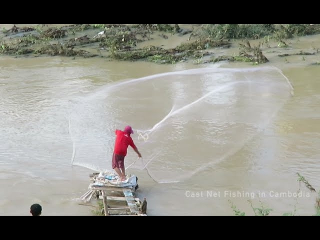 Traditional Asian fishermen throwing net fishing in the river at