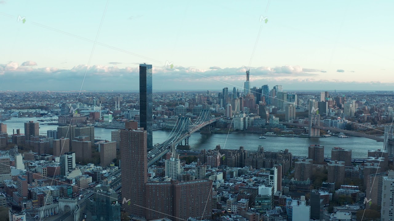 Slide and pan footage of Manhattan bridge with heavy traffic. High rise apartment building One