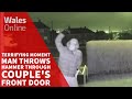 Terrifying moment man throws hammer through couple's front door