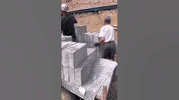 The process of quickly loading concrete blocks onto a truck for transport