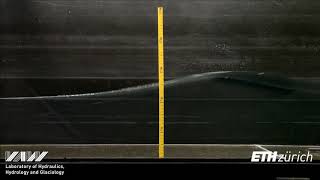 Solitary impulse wave transformation to overland flow