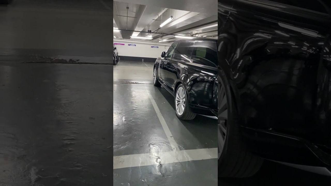 Person Showing Car Without License Plate in Parking Lot
