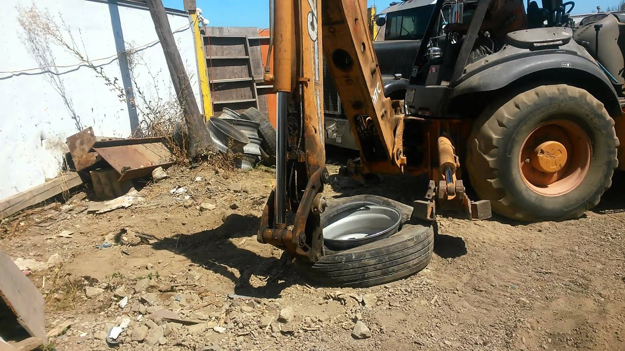 First try, Backhoe putting tire and rim together YouTube
