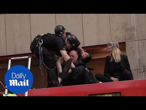 Authorities arrest climate change protesters glued to London train