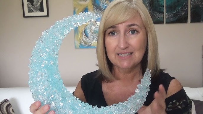 Break up glass pebbles into crushed glass for resin geode art