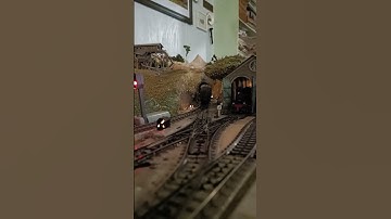 Marklin analog DB 4-6-4 passenger train leaving station and going through tunnel