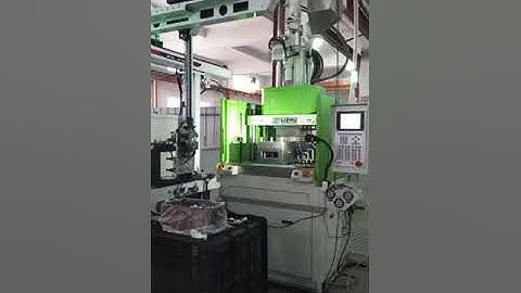 Vertical injection molding machine with rotary table and automation system