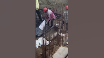 Worker emptying bags of gravel #construction #workers #work #gravel #building #highrise #foudation