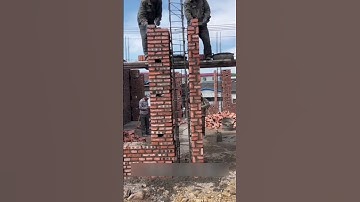 Ingenious skill of construction worker making high brick column