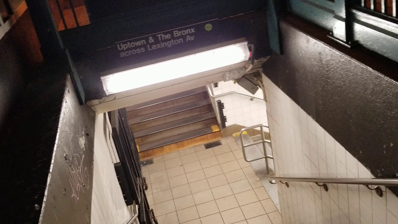 DOWN STAIRS TO SUBWAY AT 86TH AND LEXINGTON AVENUE AT NIGHT - MANHATTAN, NEW YORK CITY