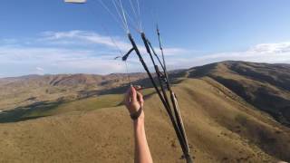 Hands up flying steering with C-risers ridge soaring paragliding near Horseshoe Bend Idaho