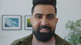 Close-Up Portrait Of Middle Eastern Man Looking At Camera With Serious Face Then Smiling At Home