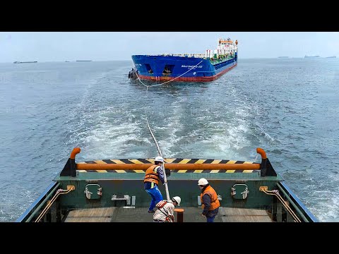 A Day in the Life of a Tiny But Powerful Tugboat Towing Gigantic Ships at Sea