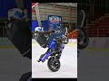 Motorcycle wheelie on ice- hockey stadium