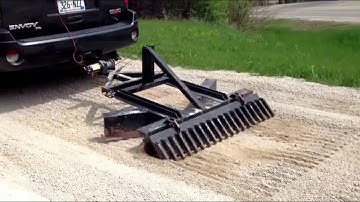 SUV grading the driveway with hitch-n-plow