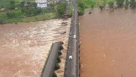 Bridge collapse sends two buses into river