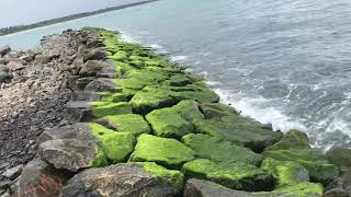 When sea waves meet a heavy structure. Breakwater construction.