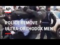 Police forcibly remove ultraorthodox men blocking jerusalem street over potential new draft law