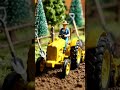 miniature work village life style farmers working in land with tractor