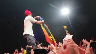 TYLER JOSEPH HOLDING A PRIDE FLAG