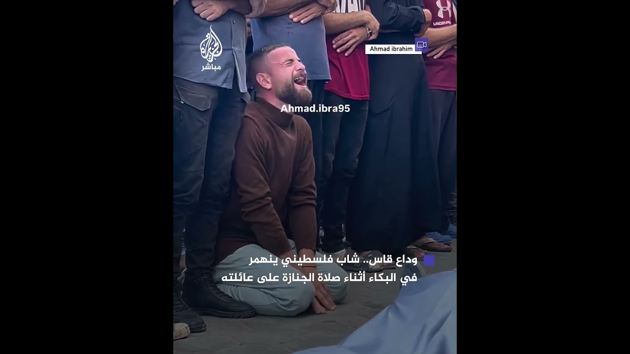 شاب فلسطيني يودع عائلته التي استشهدت جراء الاستهداف الإسرائيلي لمدرسة رفيديا غربي دير البلح بغزة