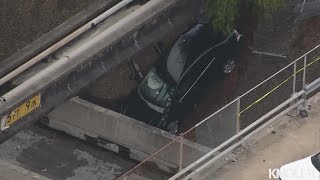 Raw video: Car ends up on freeway embankment after crash in downtown Houston