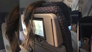 Woman Blocks Plane Passenger's TV By Placing Long Ponytail Over It