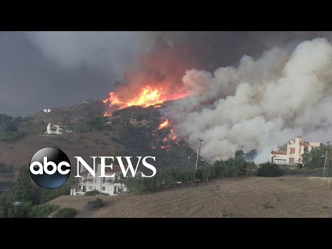 Fast-moving fires force mass evacuations in southern California