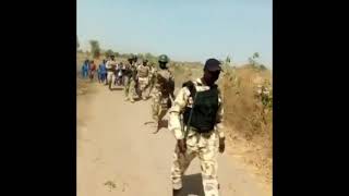 Soldiers accompanying children to school in North-Eastern Nigeria.