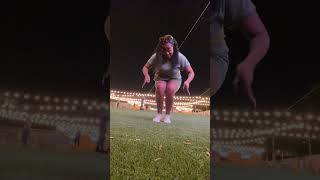 Energetic Woman Dancing Outdoors At Night