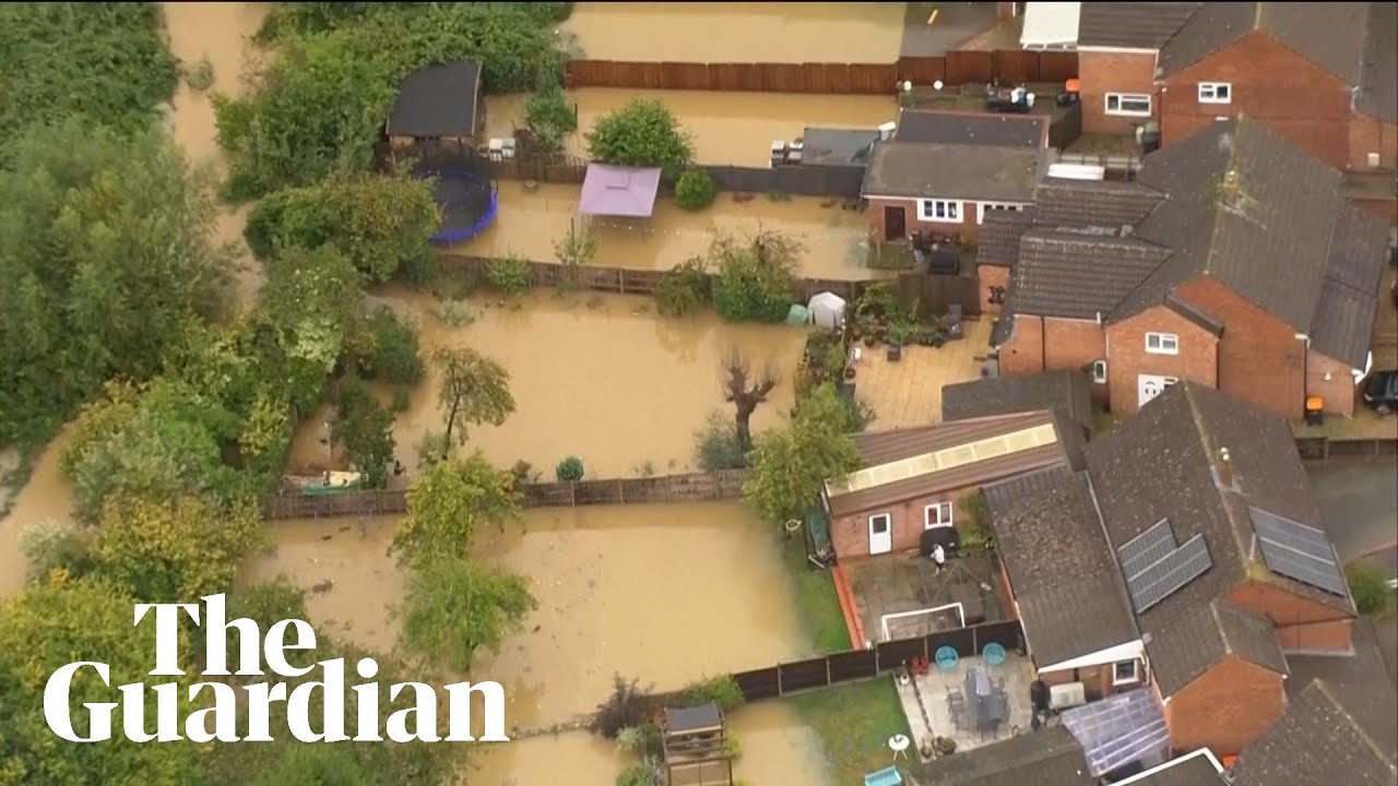 UK flooding: Heavy rains inundate parts of Britain, wash out roads | Guardian News