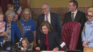 Gov. Kim Reynolds signs cancer bills into law