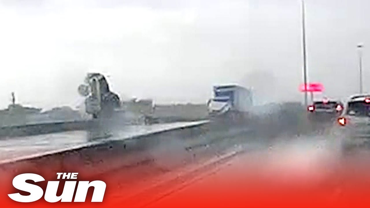 Driver dives to safety just in time as 18-wheeled truck flips over ...
