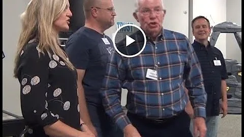 Clayne Robison helps all 12 singers find the drone...