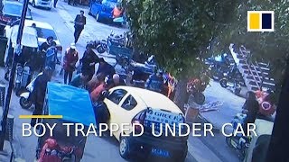 Boy rescued after being run over by car in east China